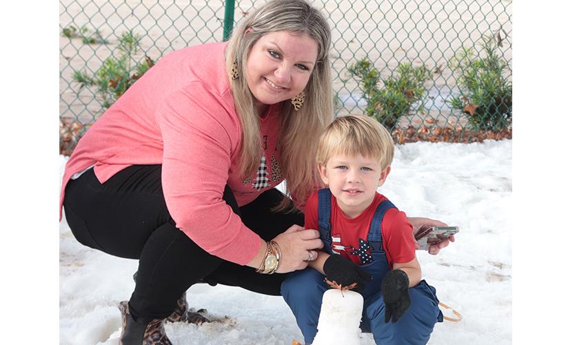 Mom and son making snow man