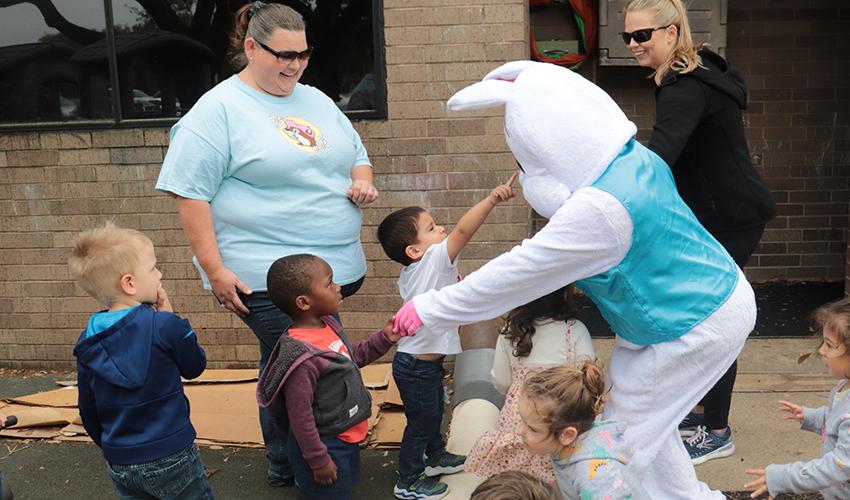 Mr. Bunny shaking little kids' hands.