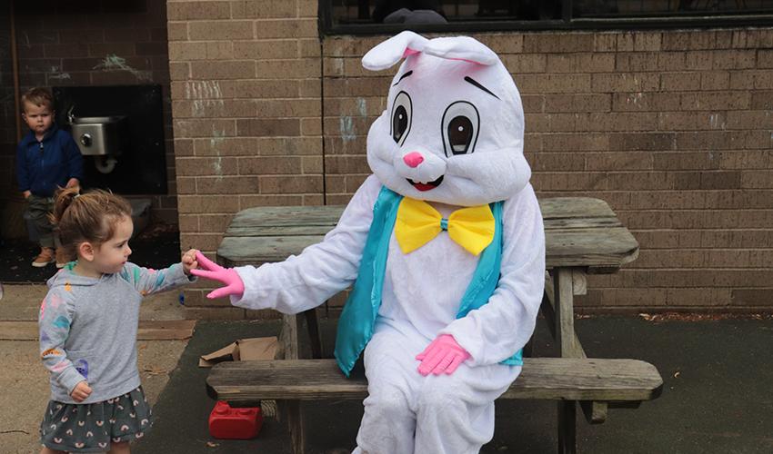 Mr. Bunny giving a girl a high five.