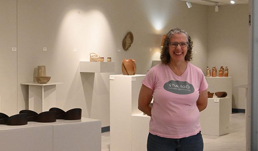 Karen Fiscus posing in front of her art.